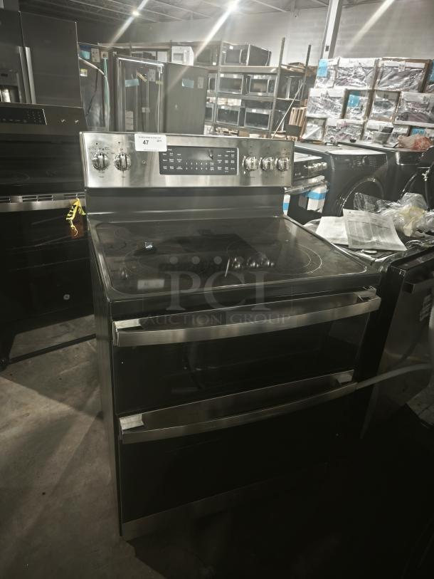 GE JBS86SPSS double oven convection range, freestanding, electric, new condition with minor scratches, control panel visible.