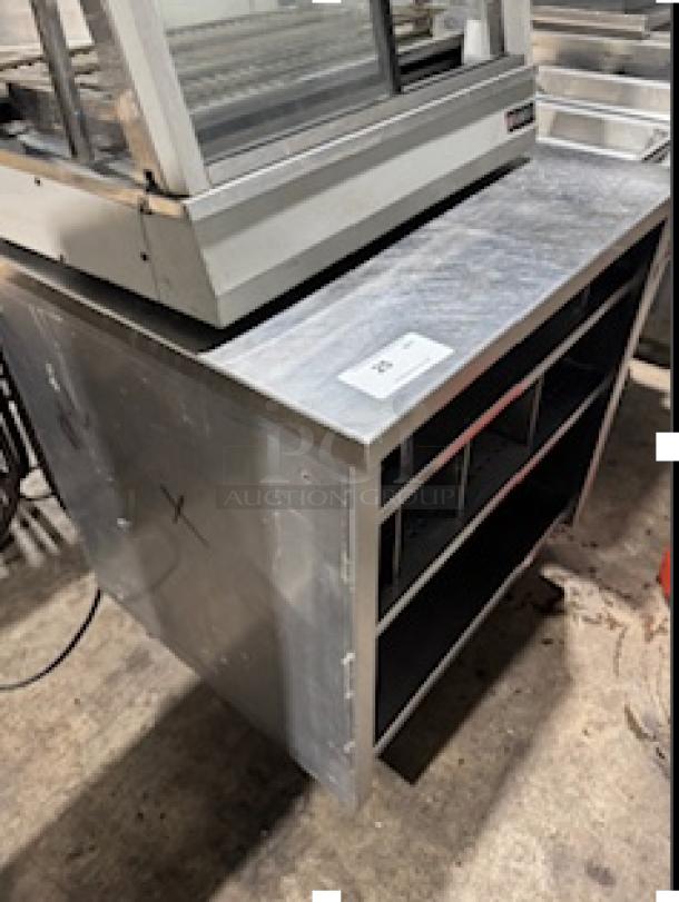 NICE CUSTOM STAINLESS STEEL TABLE by S&G Manufacturing, Model BERS27. Features shelves, sturdy build, good condition.