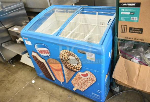 AHT RIO S 100 commercial chest freezer on casters, Nestlé branding, missing glass pane on right lid, 115V, tested, working.