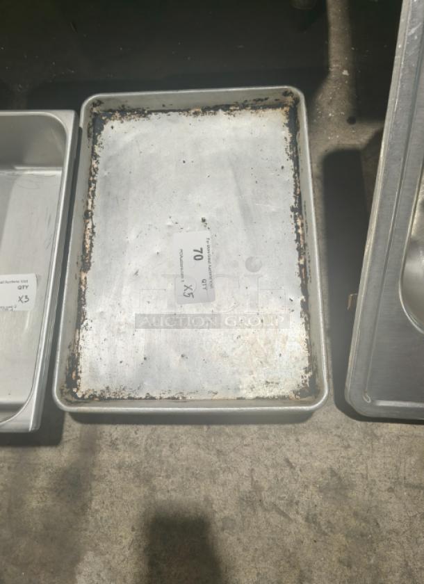 Commercial heavy-duty aluminum half-sheet pan, visible wear and discoloration, label indicates quantity of 5.
