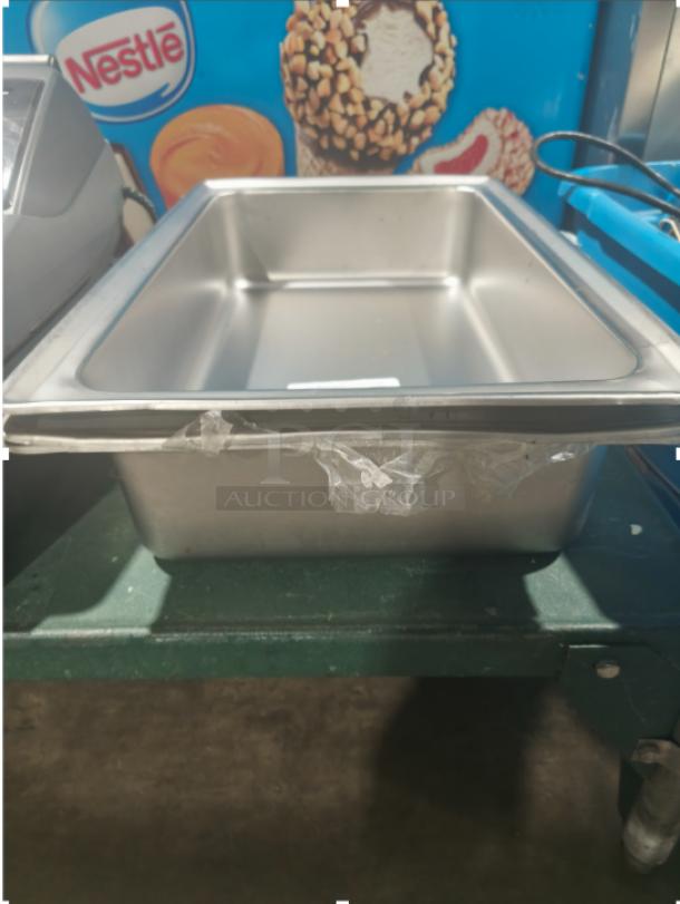 Brand new stainless steel full-size hotel pan, 4" deep, pristine condition, wrapped in plastic, durable and versatile.