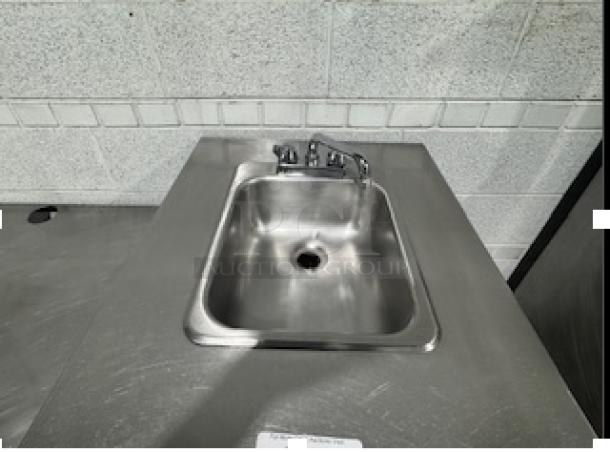 Custom stainless steel table with single sink, metal faucet, and drain. Excellent condition; ideal for kitchen use.