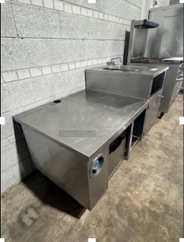 Custom stainless steel table with single sink, industrial design, under-storage, excellent condition, no visible labels.
