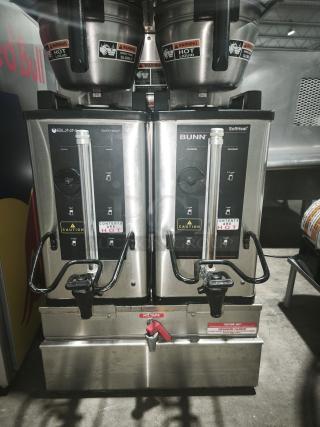 BUNN Soft Heat Dual Coffee Brewer System, model SH DBC. Features dual brewing stations, stainless steel. Labels indicate hot liquid caution.