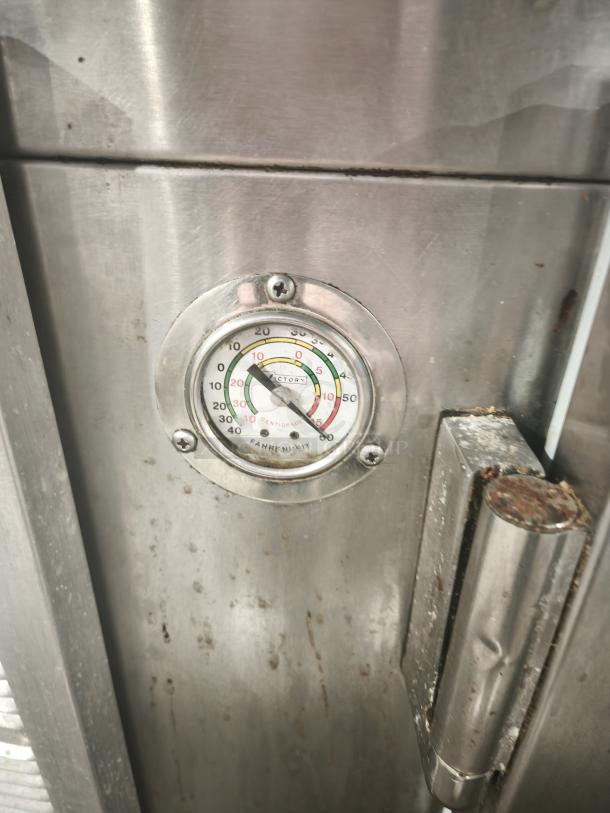 Victory Model URS‑2S2 commercial refrigerator prep table with visible thermometer on stainless steel door, slight wear.
