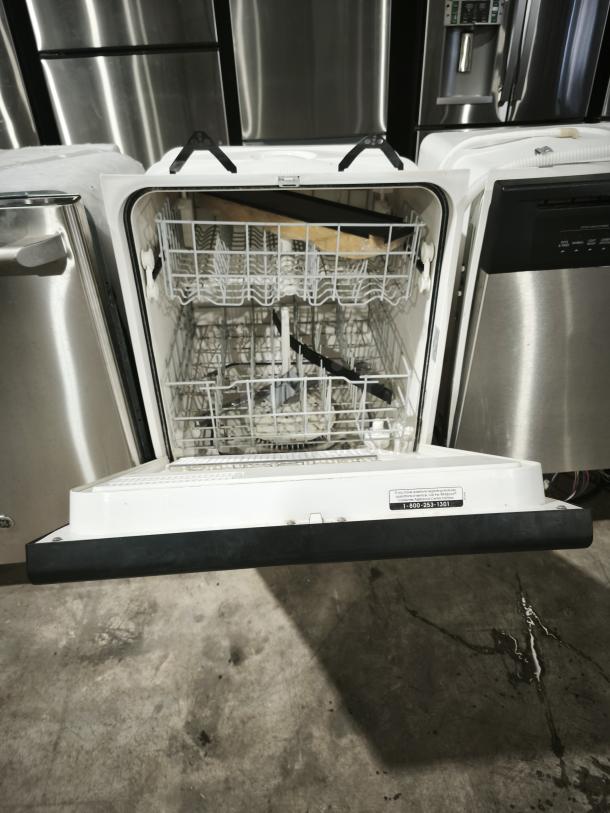 Whirlpool undercounter dishwasher, GE model DU925QWDB0, open view showing racks, in used condition. Markings include model info on door.