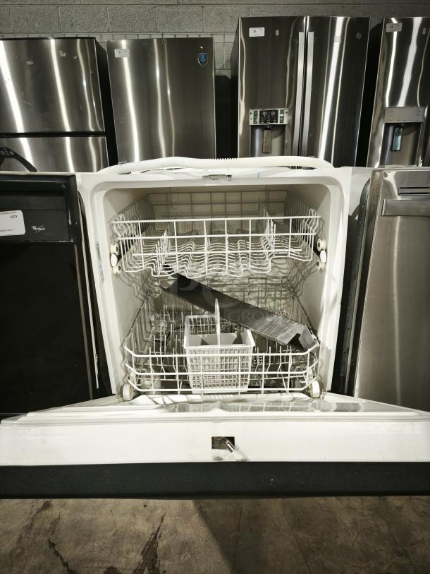 GE Built-In Full-Console Dishwasher model gsd3960L00ss, open door, interior racks visible, in appliance showroom.