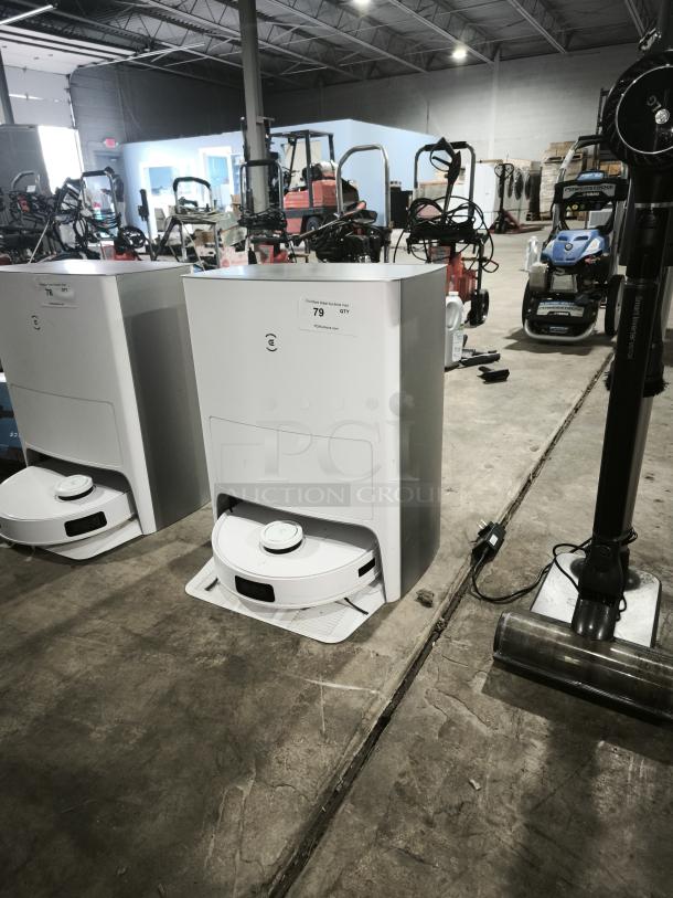 Ecovacs DEEBOT T10 OMNI, model CH2208, robot vacuum and mop with auto-cleaning station in warehouse setting.