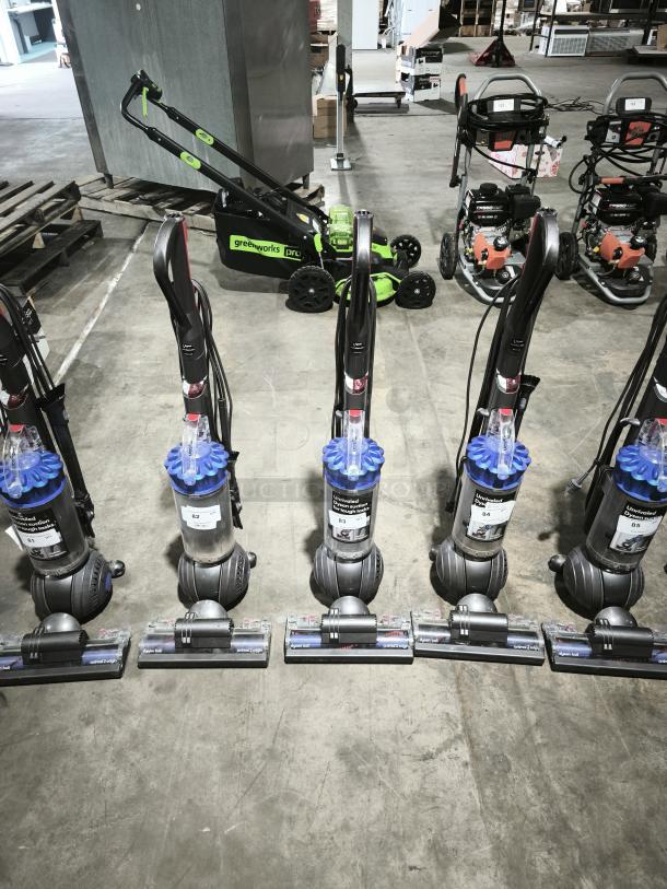 Five Dyson Ball Multi Floor 2 vacuums (Model UP19) with blue and gray design; used, labeled with numbers for auction.