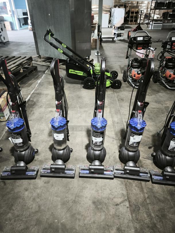 Dyson Ball Multi Floor 2 vacuums, model UP19, lined up in a warehouse. Visible labels indicate item numbers B1-B4.