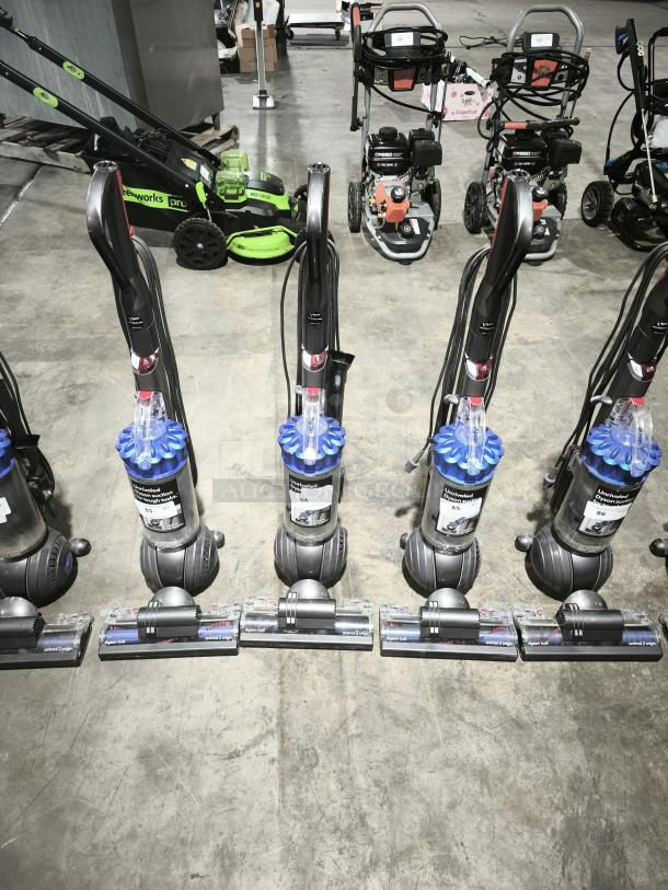 Dyson Ball Multi Floor 2 vacuums, Model UP19, on display. Features cyclonic technology, clear dust bins, in good condition.