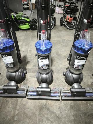 Dyson Ball Multi Floor 2 vacuums, model UP19, with blue cyclone assembly and clear dustbin. Tags label them as "Unrivaled Dyson suction."