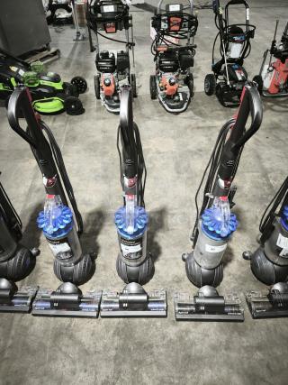 Dyson Ball Multi Floor 2 vacuums, model UP19, displayed in a row; features ball design for easy maneuvering.