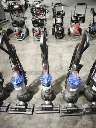 Dyson Ball Multi Floor 2 vacuum, Model UP19, in good condition. Features distinctive ball design for maneuverability. Tags display model and condition information.