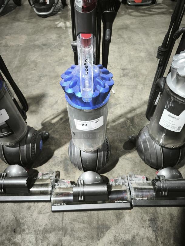 Dyson Ball Multi Floor 2 vacuum, model UP19, in good condition. Visible label reads "89." Blue cyclone component, clear bin.