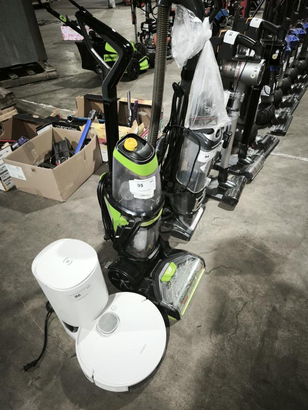 BISSELL ProHeat 2X Revolution Pet Carpet Cleaner, Model 1548, green and black, in good condition with visible cleaning accessories.