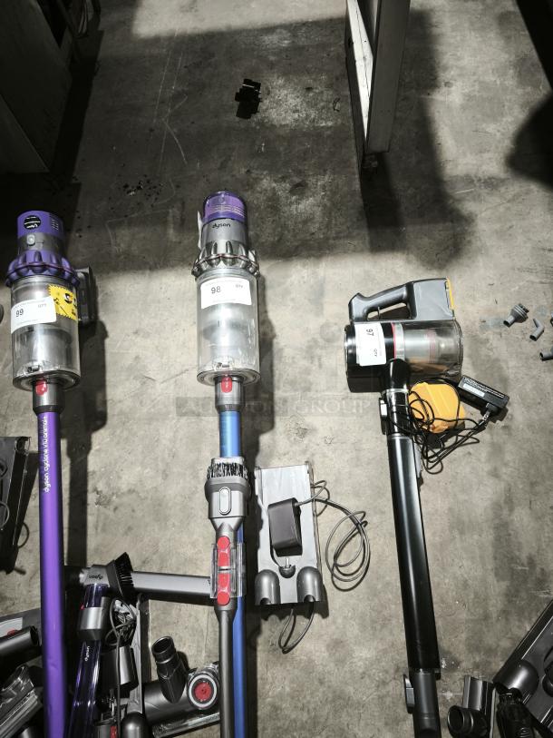 Dyson V11 Torque Drive PLUS cordless vacuum in blue. Includes charger and attachments. Item number 98. Appears gently used.