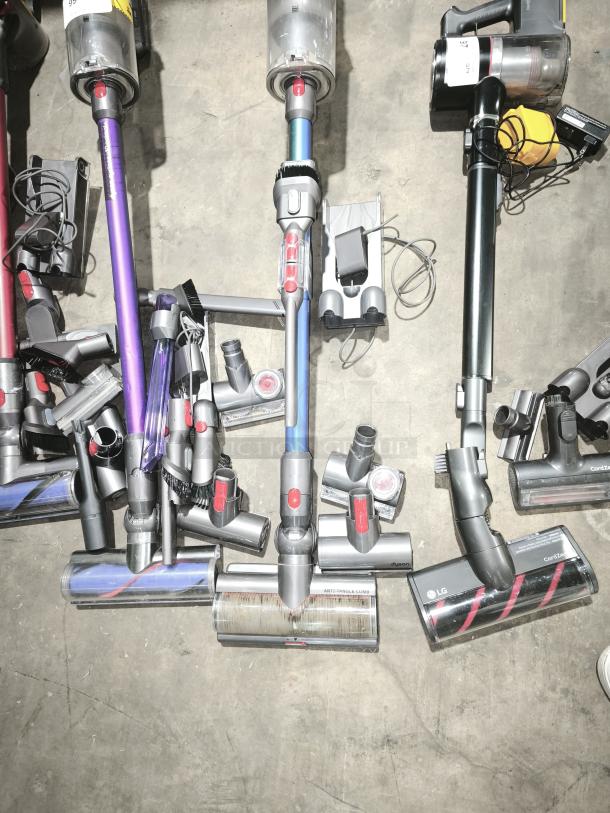 Dyson V11 Torque Drive PLUS Cordless Vacuum, multiple attachments, used, visible labeling, blue and gray color scheme.