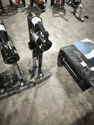 LG CordZero A9 Cordless Stick Vacuum A916BM on display, near its box, showing labeling and accessories on a concrete floor.