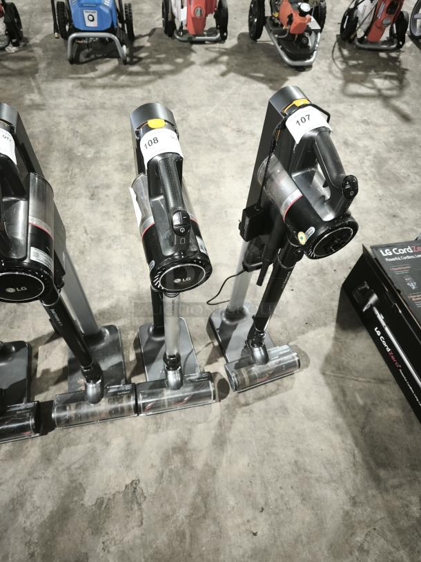 LG CordZero A9 cordless stick vacuum, model A916BM, displayed with multiple units, tags 107 and 108, in good condition.