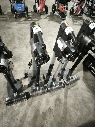 LG CordZero A9 cordless stick vacuums, model A916BM, displayed in a row. Includes visible auction tags, good condition.