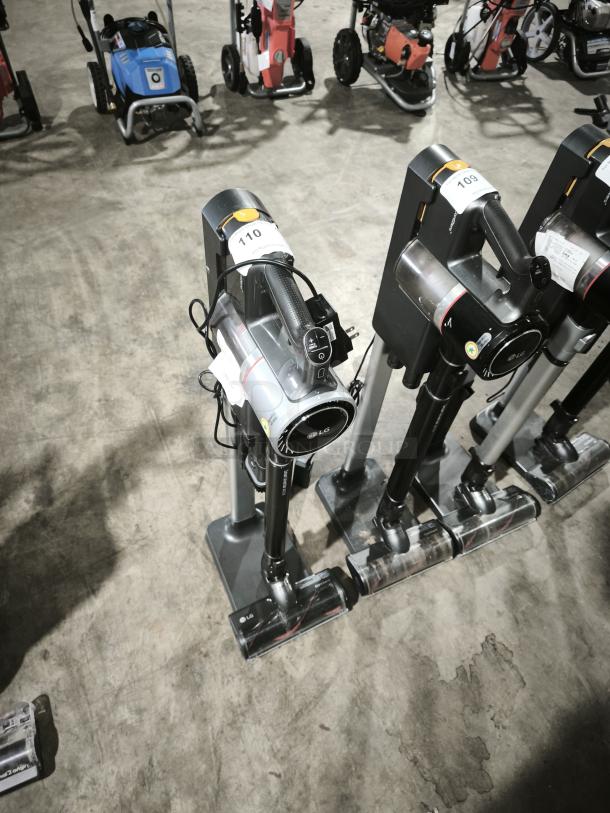 LG CordZero A9 Cordless Stick Vacuum, model A916BM, displayed upright on stand. Visible LG branding, auction tag 110.