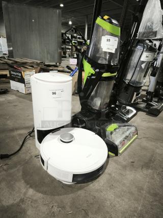 White DEEBOT robotic vacuum and charging base, in good condition. Visible markings: "For More Great Auctions Visit PCAuctions.com."