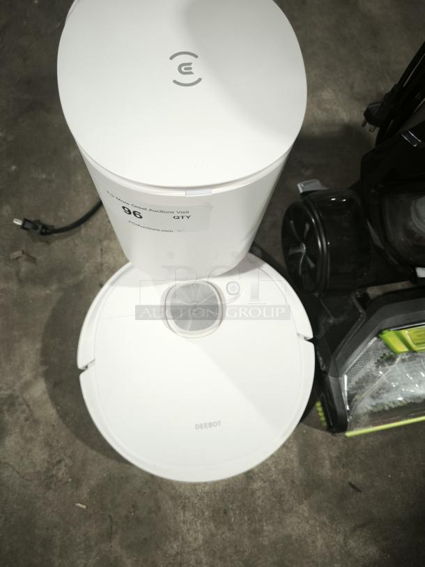 DEEBOT robotic vacuum with charging station, white, clean condition, label indicating auction information attached.