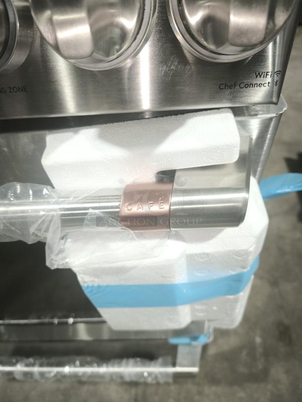 New GE Café 30" Smart Slide-In Range CES700P2MS1, radiant, convection, WiFi-enabled with 'CAFE' handle tag, shipping packaging.