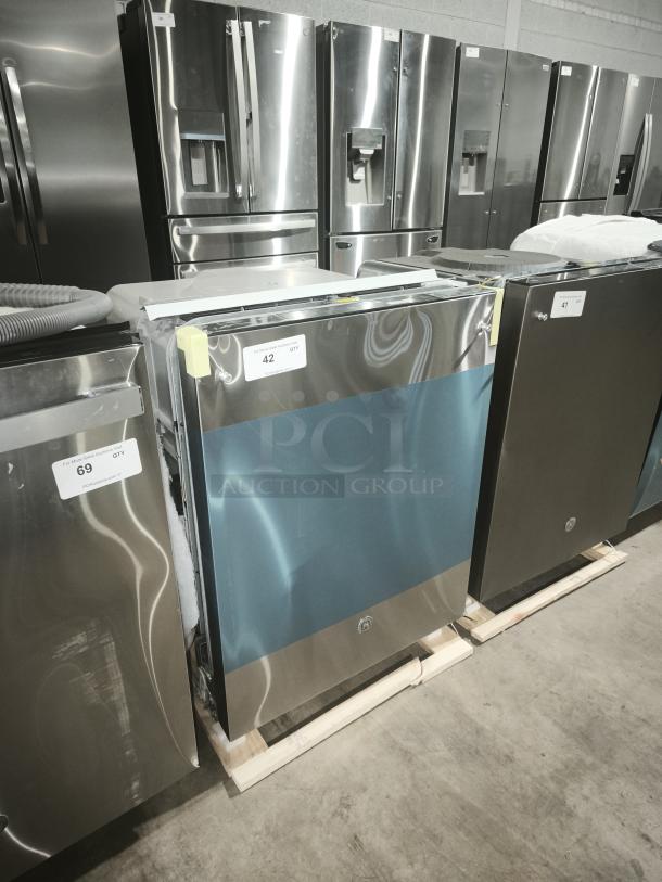 Brand new GE dishwasher, model GDT665SSNSS, with top control, scratches noted. Features Sanitize Cycle and Dry Boost™.