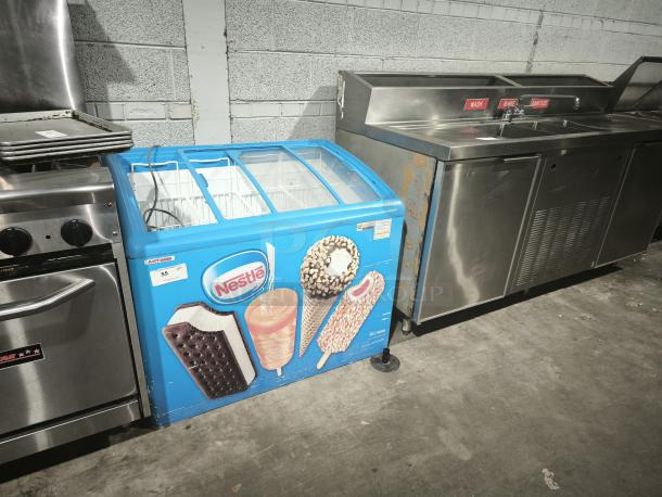AHT RIO S 100 commercial chest freezer on casters with missing glass pane on right lid, 115 volts, tested working.