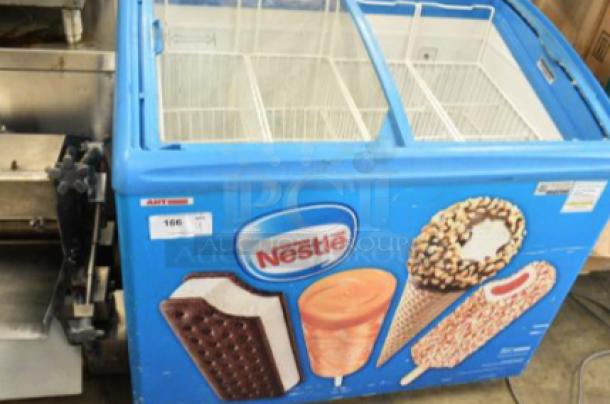 AHT RIO S 100 commercial chest freezer with Nestle branding, missing right side glass pane, on commercial casters, 115V, tested and working.