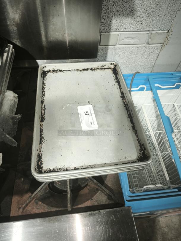 Heavy-duty aluminum half-sheet pan, commercial grade, visibly worn edges, auction tag "57" attached.