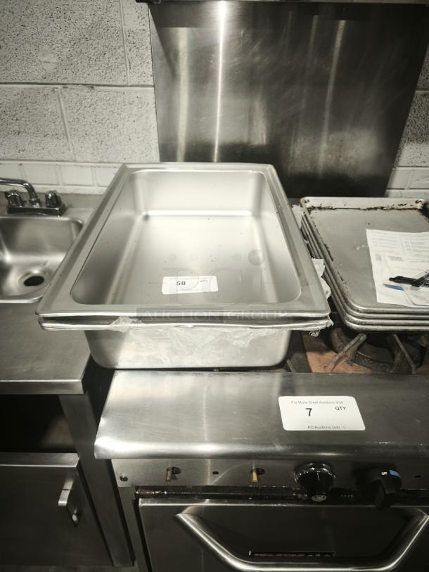 Brand new stainless steel full-size hotel pan, 4" deep, pristine condition, visible auction tag indicating item number 58.