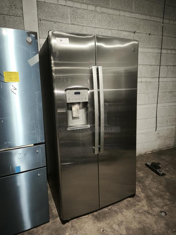 GE 21.8 cu ft side-by-side refrigerator, model GZS22IYNFS, stainless steel, fingerprint-resistant, visible dispenser panel.