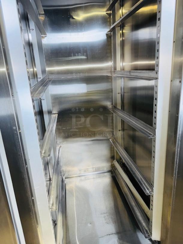 Traulsen RHT132WUT-FHS stainless steel refrigerator, 24.2 cu. ft., like new condition, interior shelving visible.