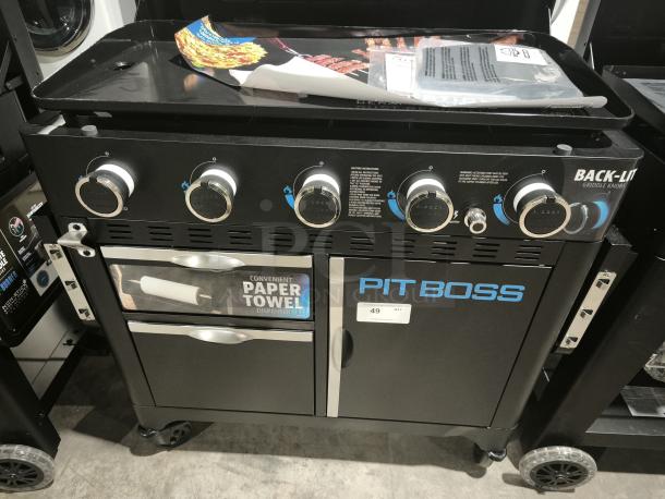 Pit Boss PB5BGD2 Ultimate 5-Burner Griddle, brand new, features back-lit knobs, paper towel holder, and storage cabinet.
