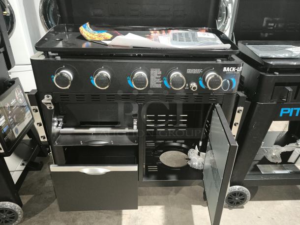 Brand new Pit Boss PB5BGD2 Ultimate 5-Burner Griddle, featuring back-lit knobs, storage drawer, and side cabinet.