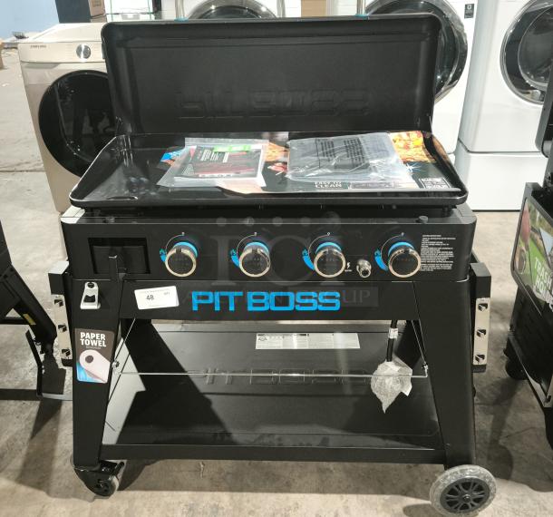 Pit Boss Ultimate 4‑Burner Lift‑Off Griddle, model 10782, brand new, with controls and paper towel holder.