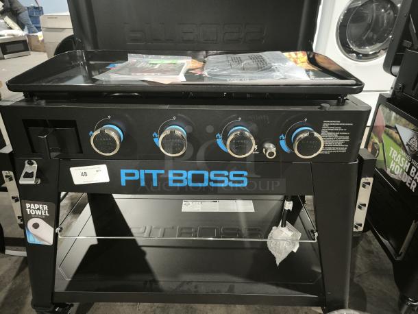 Pit Boss Ultimate 4-Burner Griddle, model 10782, brand new condition. Features lift-off design, control knobs, storage shelf.