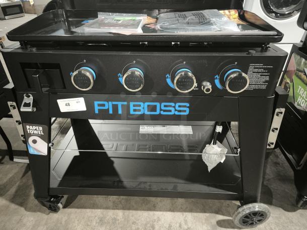 Pit Boss Ultimate 4-Burner Griddle, Model 10782, brand new. Features lift-off design, paper towel holder, and four control knobs.