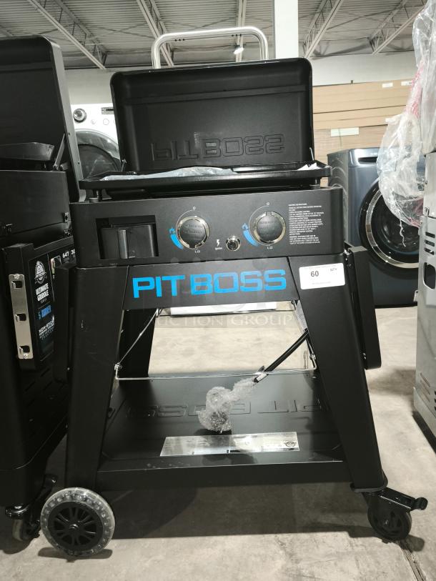 Brand new Pit Boss Ultimate Lift-Off Griddle PB2BGD2 with dual control knobs, logo, and sturdy cart.
