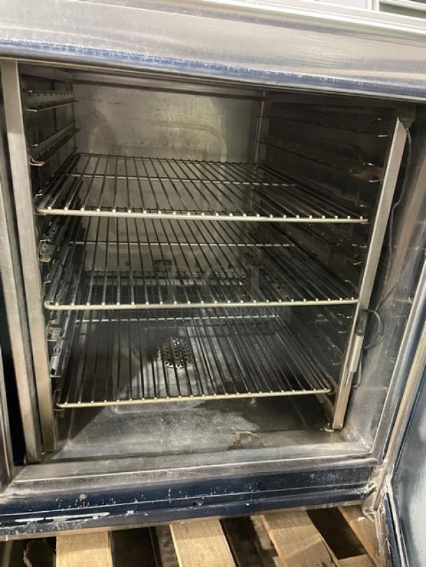 Alto-Shaam CTP720E commercial stainless steel combi oven with digital touch controls, three wire racks, on legs.