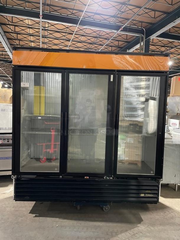 True GDM-72F commercial freezer with triple glass swing doors, black finish, poly-coated wired racks, 115/208-230V, 1 phase.