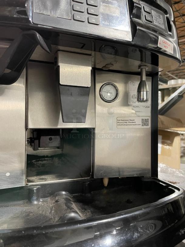 Schaerer Coffee Art Plus commercial espresso machine, model SCA1. Black/stainless steel, dual hoppers, 240V, gauges, and labeling visible.