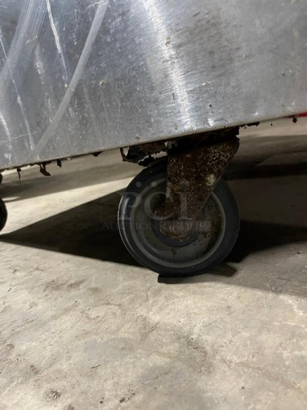 Bakers Pride 6-burner range/oven on caster wheel, stainless steel, natural gas, model 36BP6BS30N. Rust evident on caster.