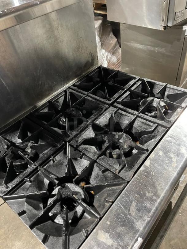 Radiance commercial stainless steel 6-burner range/oven combo, natural gas, with backsplash, overhead salamander shelf, and wired oven rack.