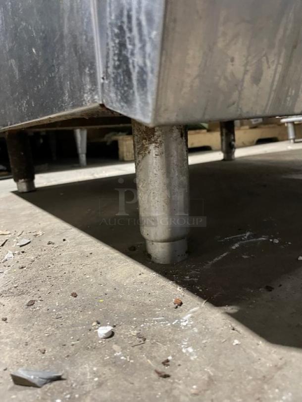 Radiance commercial stainless steel range/oven leg. Features durable metal construction. Part of a 6-burner gas setup.