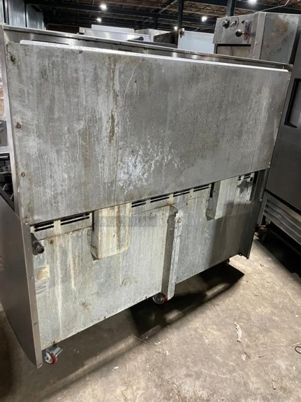 American Range 10 Burner Stove/Oven Combo, stainless steel, natural gas, with backsplash, salamander shelf, on casters, worn.