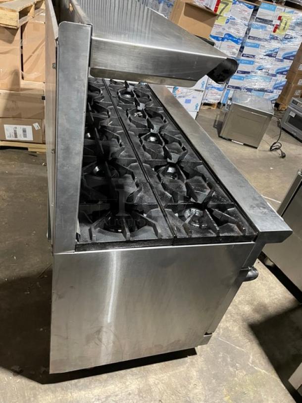 American Range stainless steel 10-burner range and double oven combo with backsplash, salamander shelf, and casters.